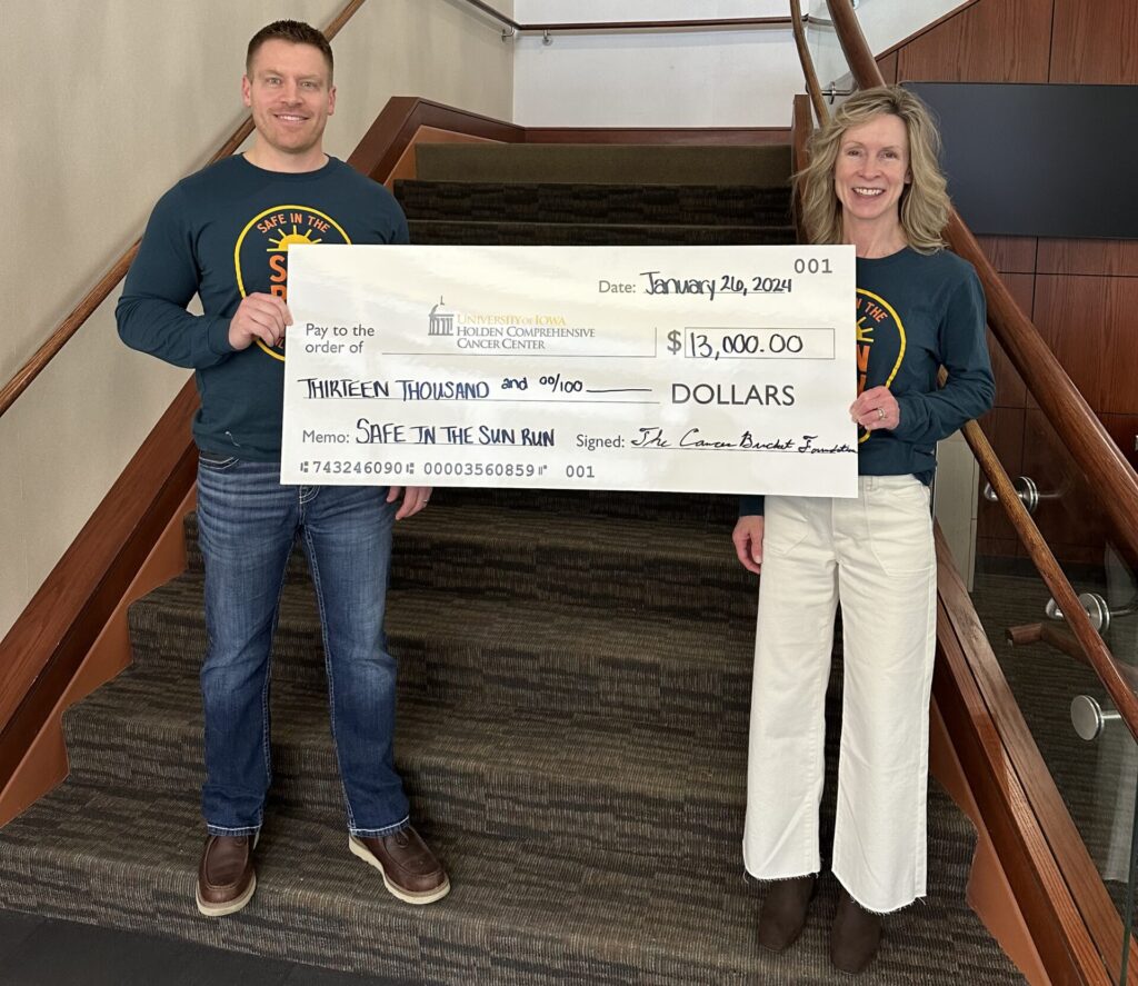 safe in the sun run cancer bucket donation gift to University of Iowa cancer center